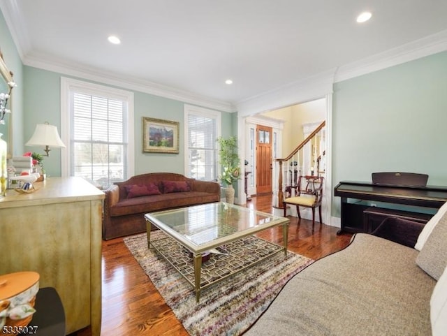 living room featuring dark wood-type flooring and ornamental molding