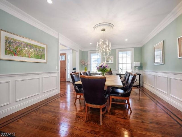 dining room featuring ornamental molding, dark hardwood / wood-style floors, and an inviting chandelier