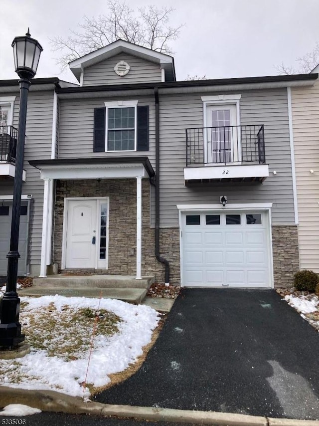 view of front of property featuring a balcony and a garage