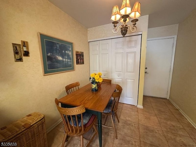 dining room with light tile patterned floors and a chandelier