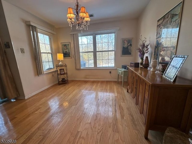 interior space featuring a chandelier and light hardwood / wood-style floors