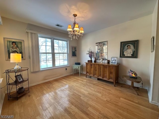 misc room featuring a chandelier and light hardwood / wood-style flooring