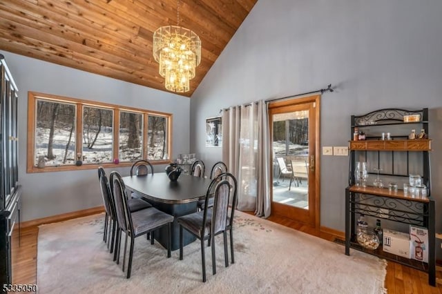 dining space featuring baseboards, wood ceiling, wood finished floors, an inviting chandelier, and high vaulted ceiling