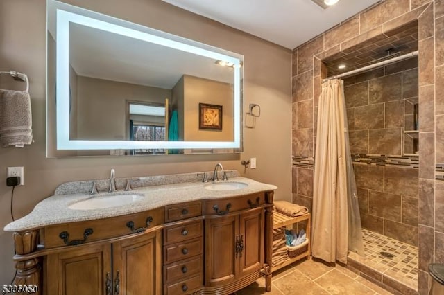 bathroom featuring double vanity, a sink, and a shower stall