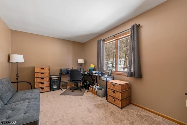 home office featuring light carpet and baseboards