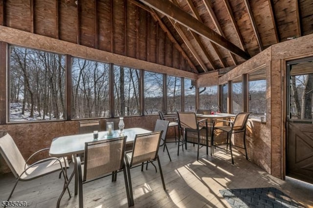 sunroom / solarium with lofted ceiling with beams