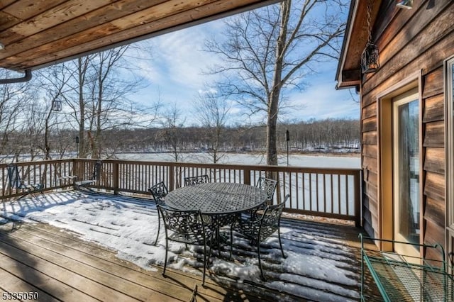 snow covered deck featuring outdoor dining space