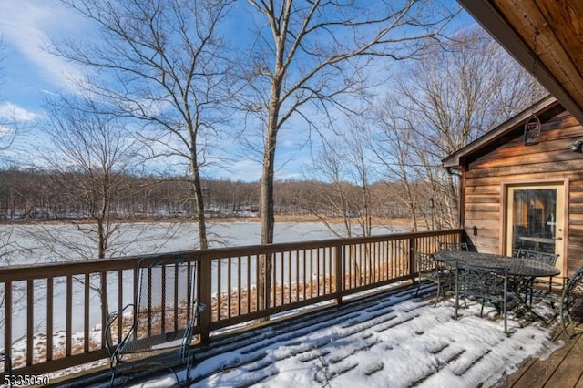 snow covered deck featuring outdoor dining area