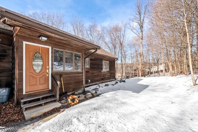 view of snow covered property entrance