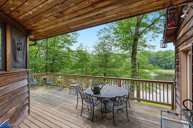 wooden deck featuring outdoor dining space and a water view