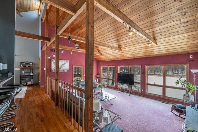 living room featuring track lighting, wood finished floors, high vaulted ceiling, wooden ceiling, and beamed ceiling