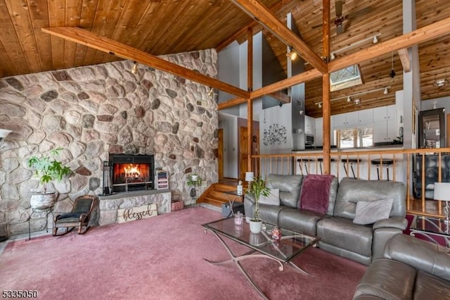 carpeted living room featuring wooden ceiling, a fireplace, and vaulted ceiling