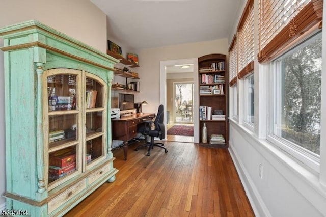 home office featuring wood-type flooring and baseboards