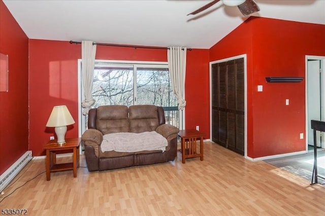 living area featuring a baseboard radiator, a ceiling fan, vaulted ceiling, and wood finished floors