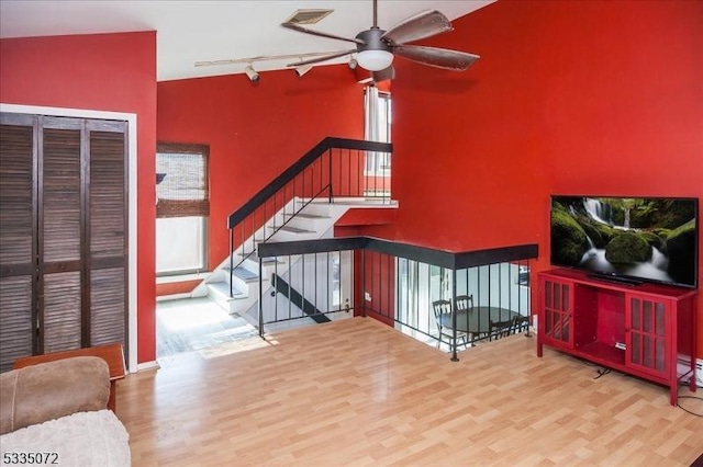 living room with ceiling fan, track lighting, and wood finished floors