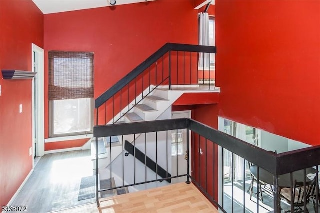 stairway with baseboards and wood finished floors