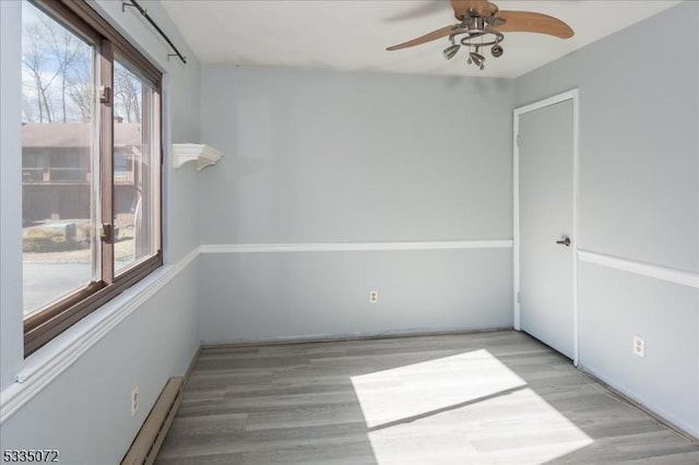 spare room featuring a ceiling fan and wood finished floors