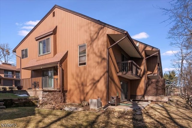 back of property with a balcony and central air condition unit