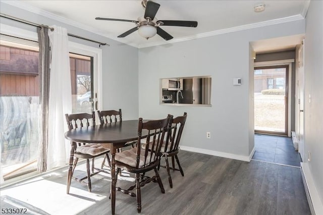 dining area featuring a ceiling fan, dark wood finished floors, crown molding, and baseboards