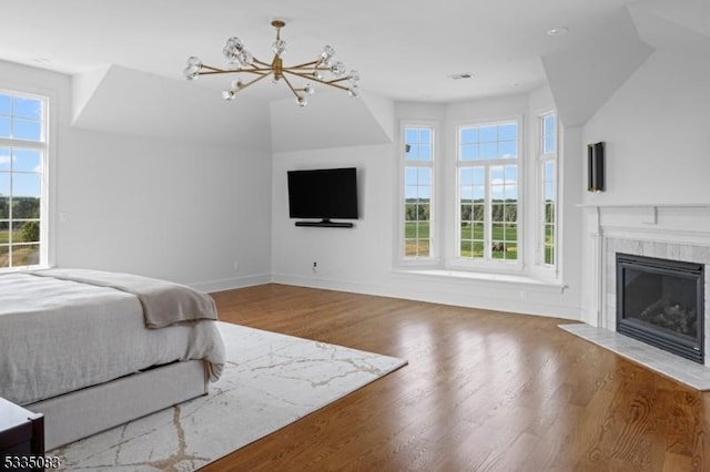 bedroom with an inviting chandelier and wood-type flooring