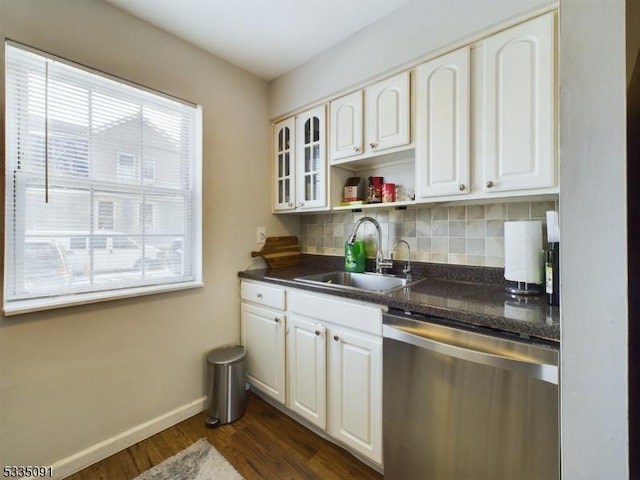 kitchen featuring tasteful backsplash, sink, stainless steel dishwasher, and white cabinets