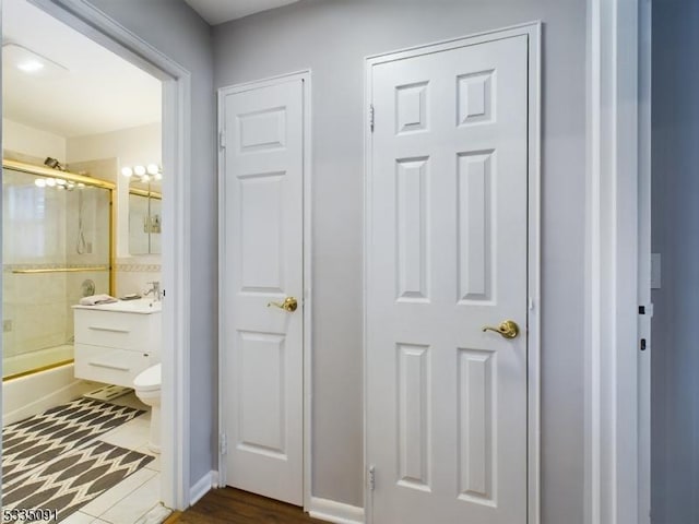 full bathroom with vanity, shower / bath combination with glass door, and toilet