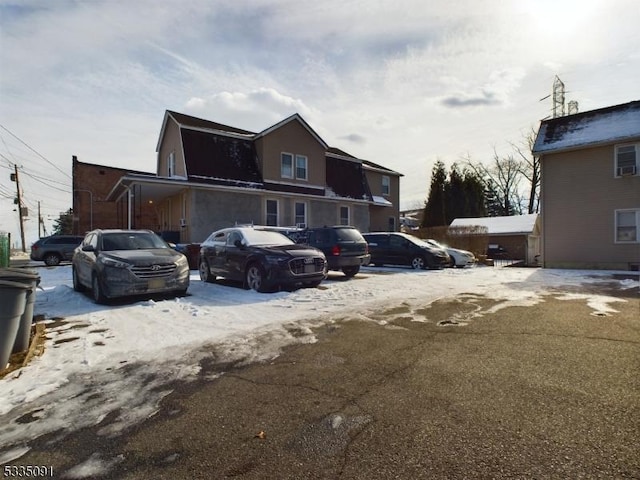 view of snow covered parking area