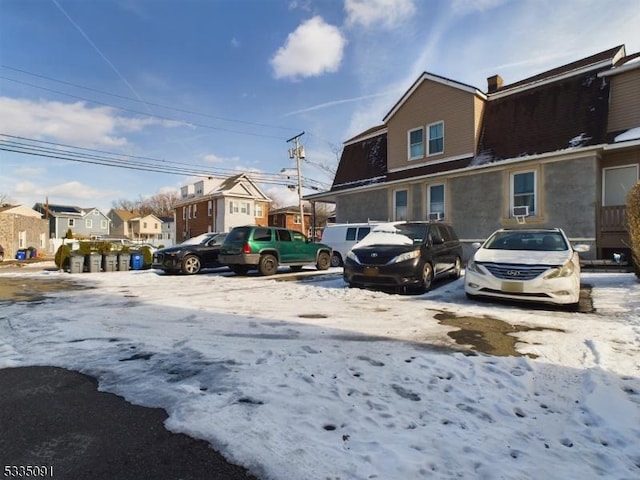 view of snow covered parking area