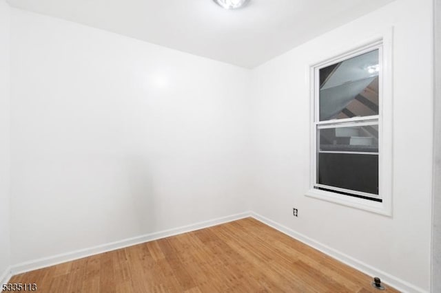 spare room with hardwood / wood-style floors