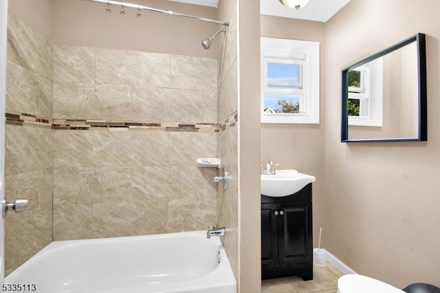 full bathroom featuring tiled shower / bath combo, vanity, tile patterned flooring, and toilet