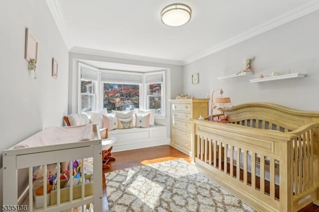 bedroom with crown molding and hardwood / wood-style flooring