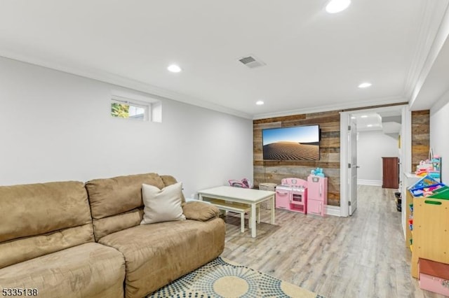 living room with crown molding and light wood-type flooring