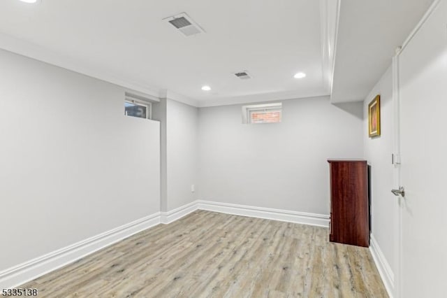 basement with light hardwood / wood-style flooring