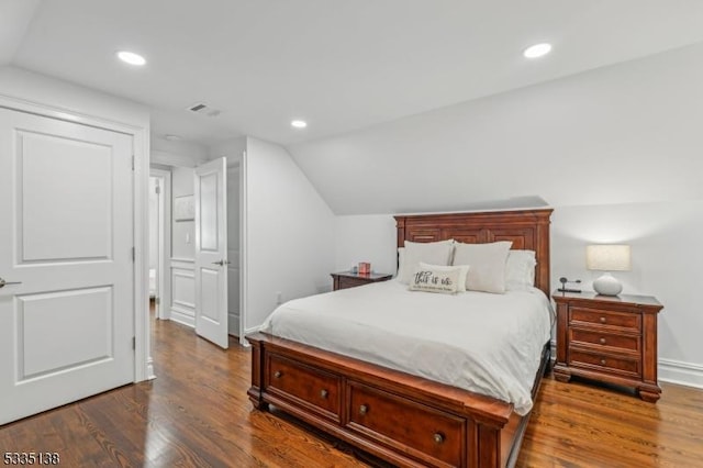 bedroom with dark hardwood / wood-style flooring and lofted ceiling