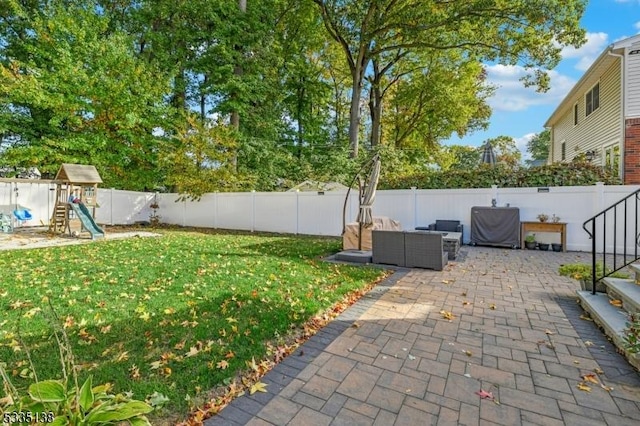 view of yard with outdoor lounge area, a playground, and a patio