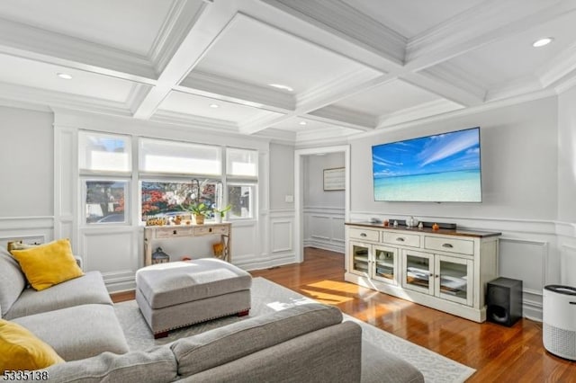 living room featuring beamed ceiling, ornamental molding, coffered ceiling, and hardwood / wood-style floors