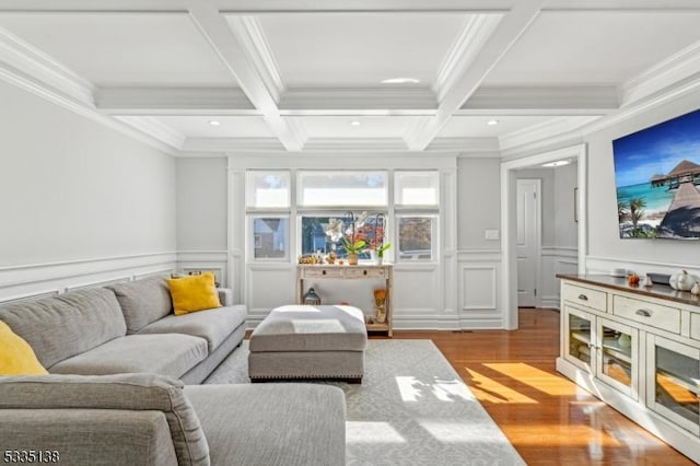 living room featuring ornamental molding, coffered ceiling, beam ceiling, and light hardwood / wood-style flooring