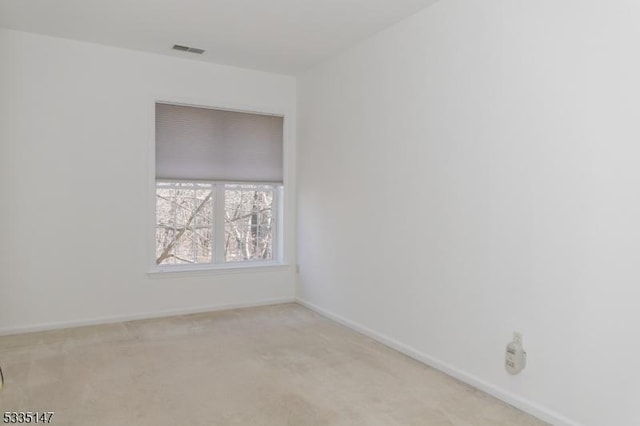 unfurnished room featuring light colored carpet