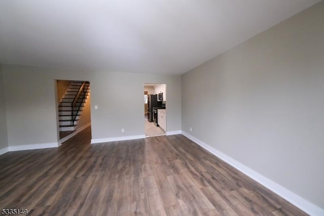 unfurnished living room featuring dark hardwood / wood-style floors