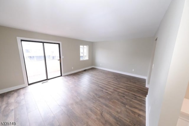 unfurnished room with dark hardwood / wood-style flooring