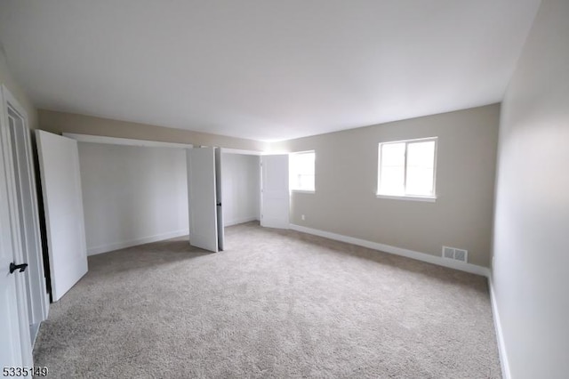 unfurnished bedroom featuring light colored carpet