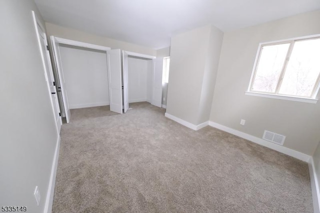 unfurnished bedroom with light carpet