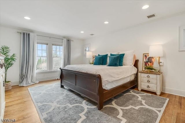 bedroom featuring recessed lighting, wood finished floors, visible vents, and baseboards