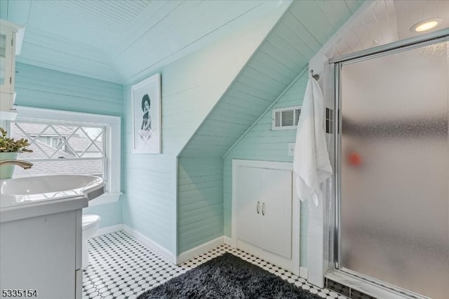 full bathroom featuring lofted ceiling, toilet, visible vents, vanity, and a shower stall