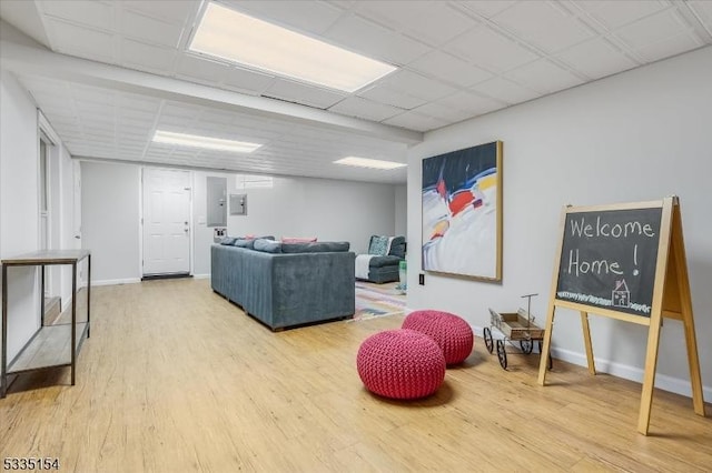 game room with wood finished floors, a paneled ceiling, and baseboards