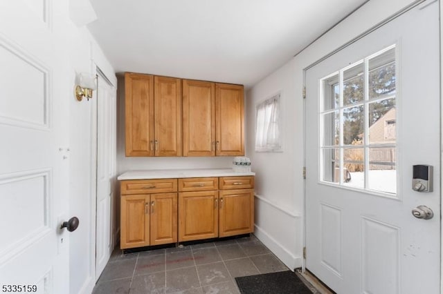 interior space with dark tile patterned flooring and a healthy amount of sunlight