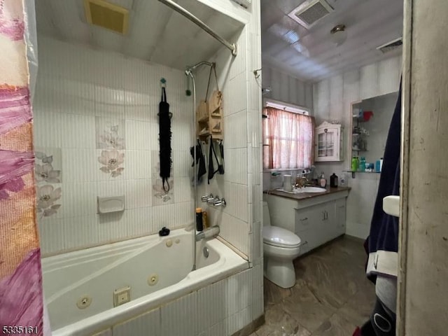 full bathroom featuring tiled shower / bath, vanity, and toilet