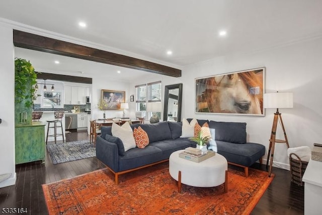 living room featuring beamed ceiling and dark hardwood / wood-style floors