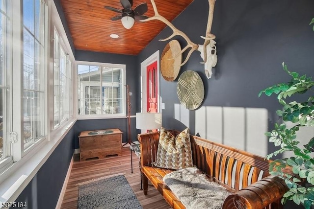 sunroom / solarium with ceiling fan and wood ceiling