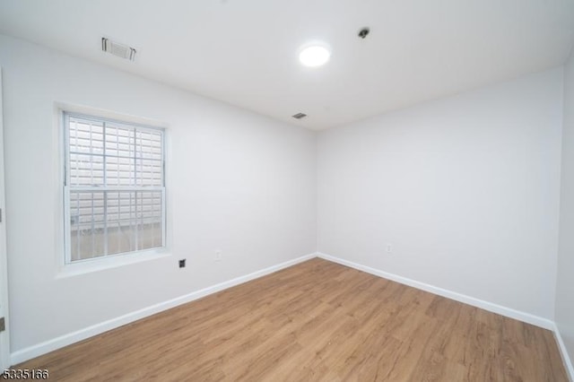 spare room featuring light hardwood / wood-style floors